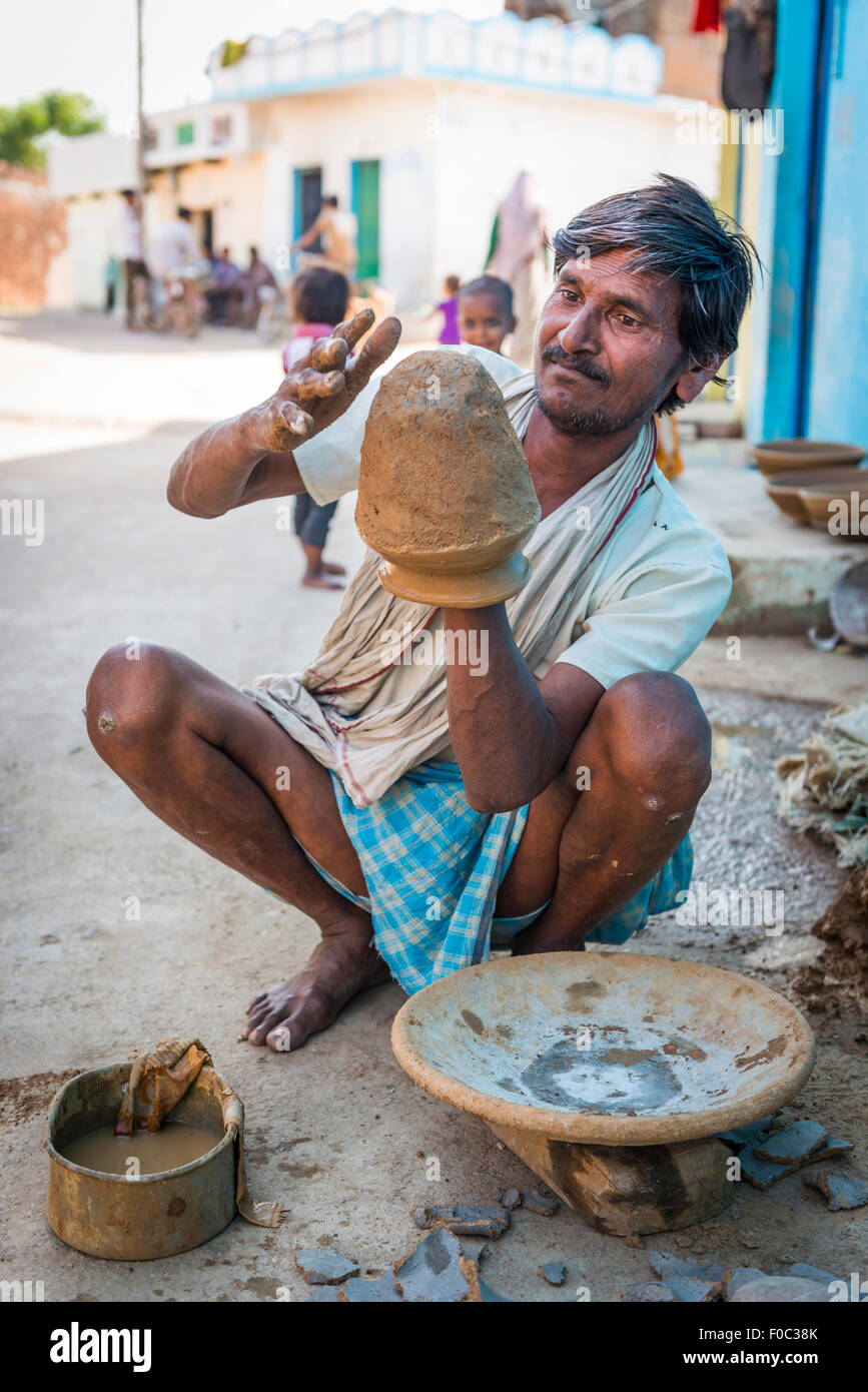 Potter throwing pots on a primitive wheel in the old part of Khajuraho, Madhya Pradesh, India Stock Photo