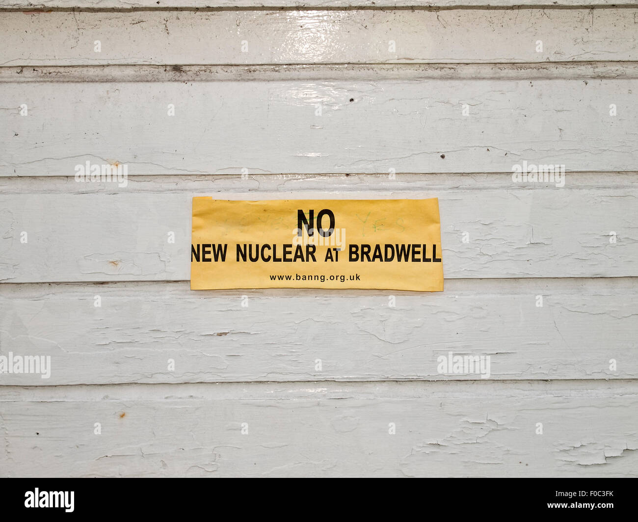 Yellow poster protesting against the Bradwell Nuclear Power Station at West Mersea. Mersea Island. Essex. England. UK. Stock Photo