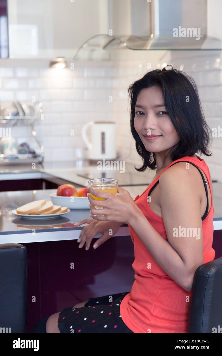 Woman with drink and food at the bar kitchen Stock Photo