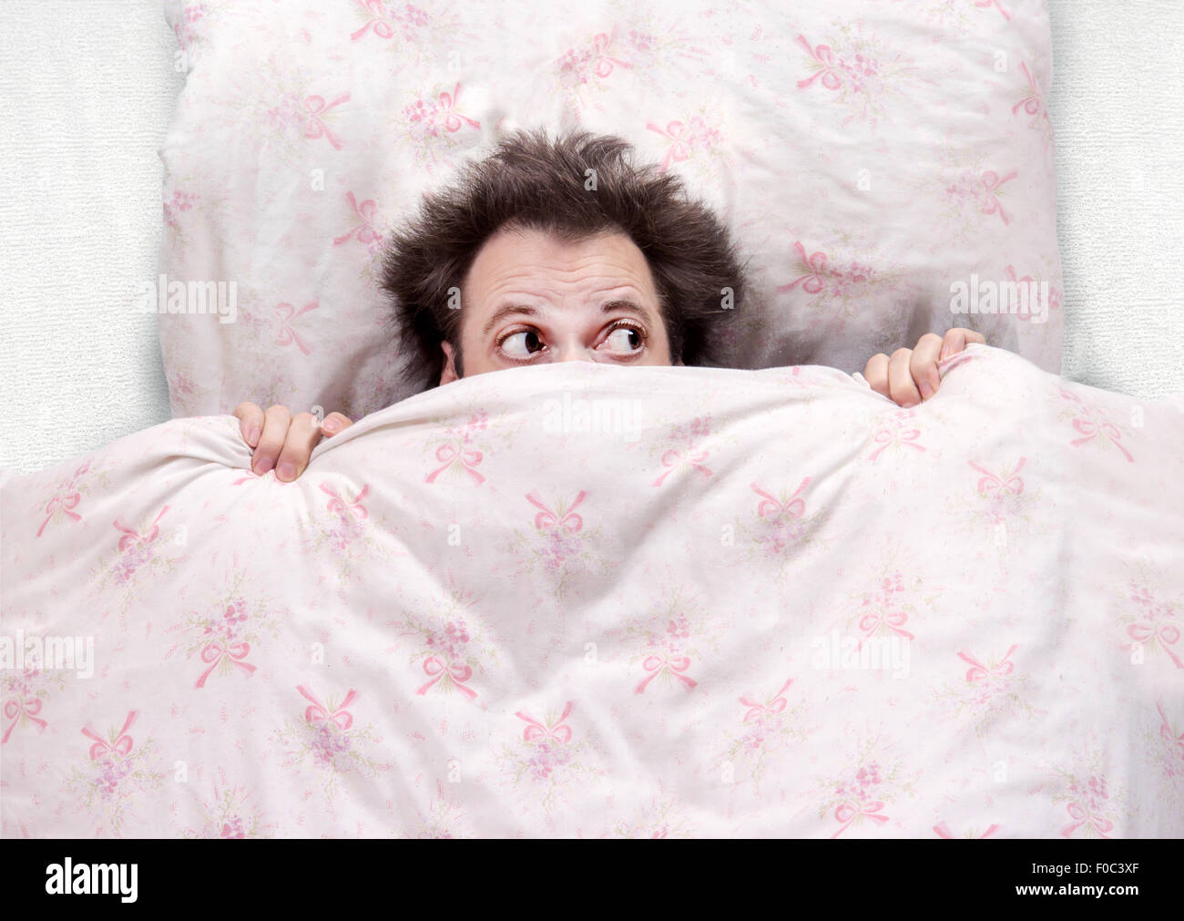 frightened man lying in bed Stock Photo Alamy
