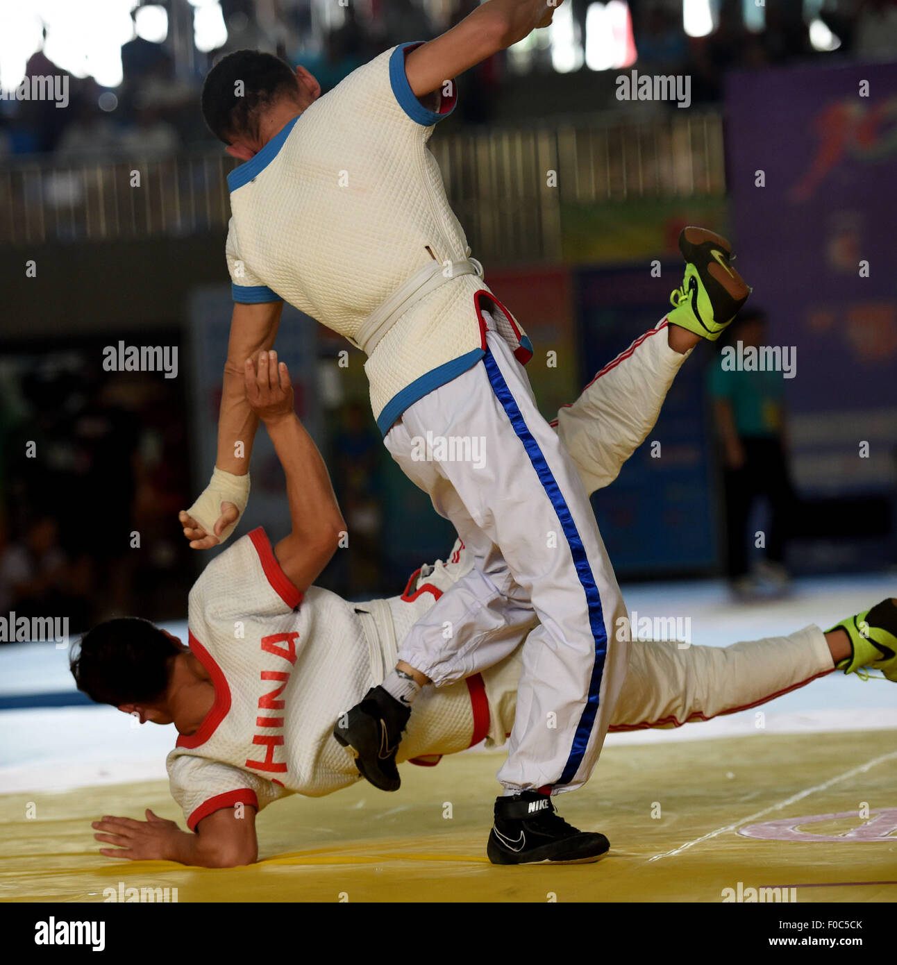 Ordos, China's Inner Mongolia Autonomous Region. 12th Aug, 2015. Athletes compete in a match of Hui-style wrestling during the 10th National Traditional Games of Ethnic Minorities of China in Ordos, north China's Inner Mongolia Autonomous Region, Aug. 12, 2015. In the event of wrestling of the ethnic minorities, athletes competed in 6 kinds of matches, namely the Tibetan-style wrestling, Mongolian-style wrestling, Korean-style wrestling, Hui-style wrestling, Yi-style wrestling and Uygurian-style wrestling. © Lin Yiguang/Xinhua/Alamy Live News Stock Photo