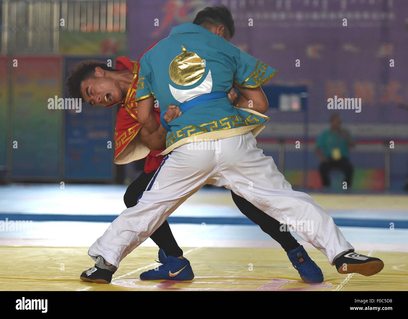Ordos, China's Inner Mongolia Autonomous Region. 12th Aug, 2015. Athletes compete in a match of Tibetan-style wrestling during the 10th National Traditional Games of Ethnic Minorities of China in Ordos, north China's Inner Mongolia Autonomous Region, Aug. 12, 2015. In the event of wrestling of the ethnic minorities, athletes competed in 6 kinds of matches, namely the Tibetan-style wrestling, Mongolian-style wrestling, Korean-style wrestling, Hui-style wrestling, Yi-style wrestling and Uygurian-style wrestling. © Lin Yiguang/Xinhua/Alamy Live News Stock Photo