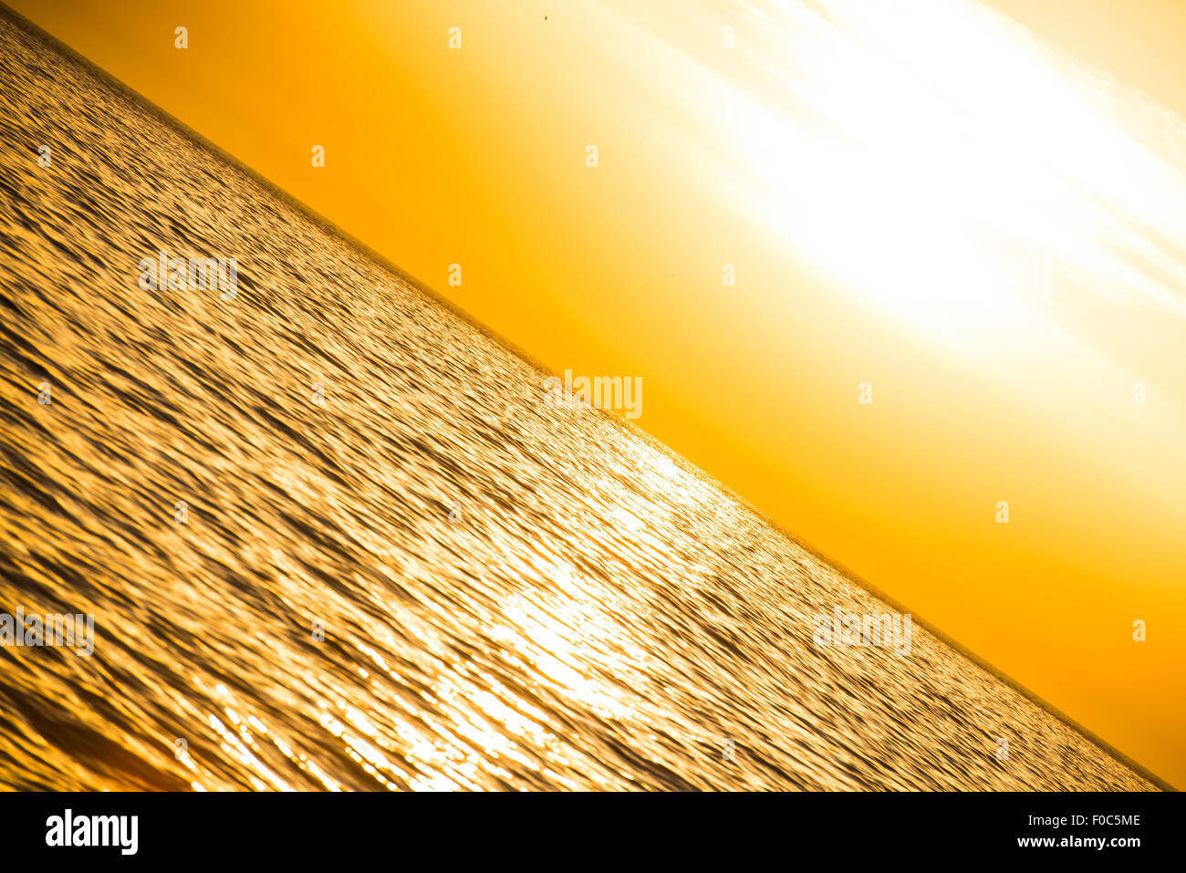 Sunset above the sea with clouds on sky Stock Photo - Alamy