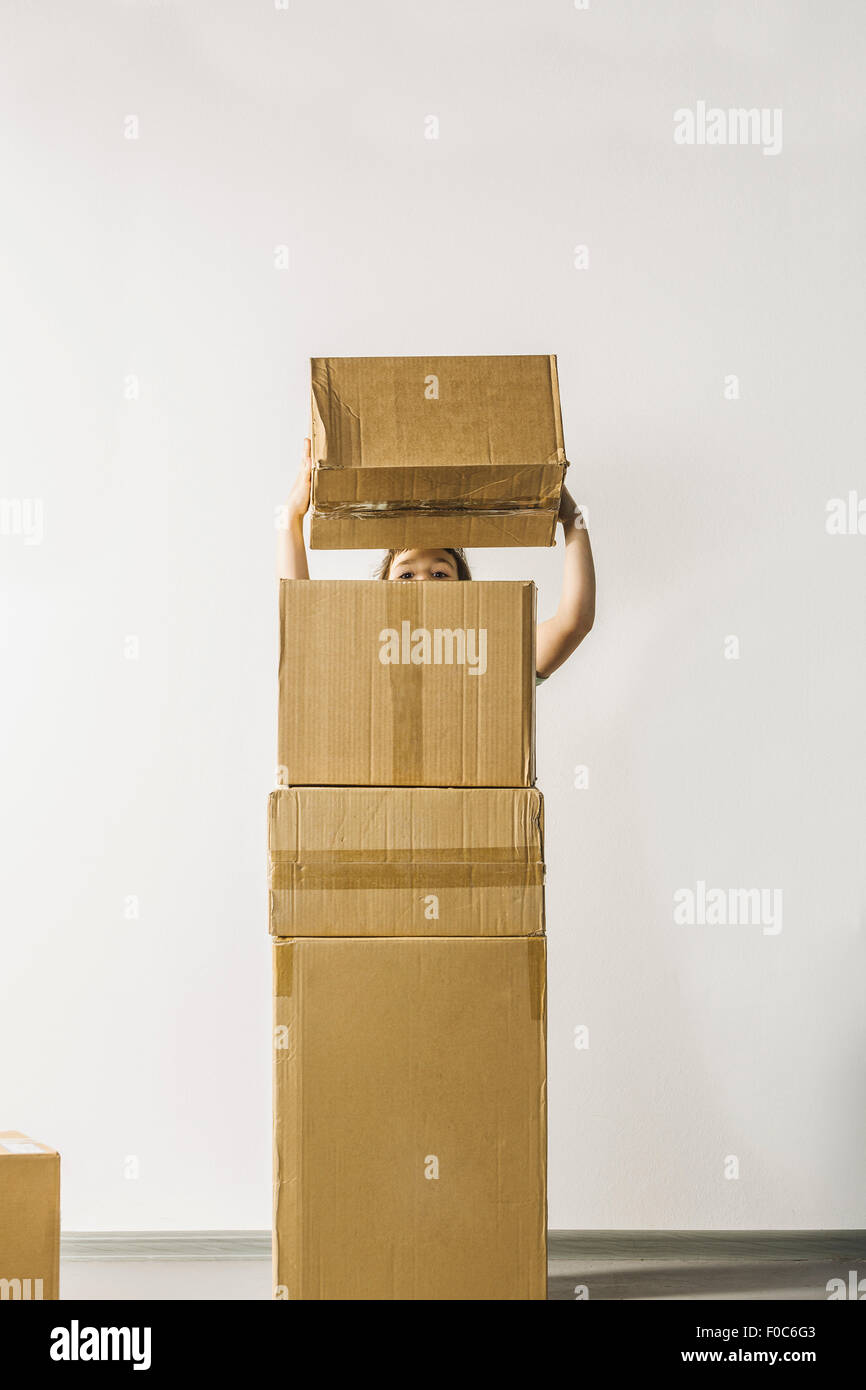 Girl stacking boxes against white background Stock Photo Alamy