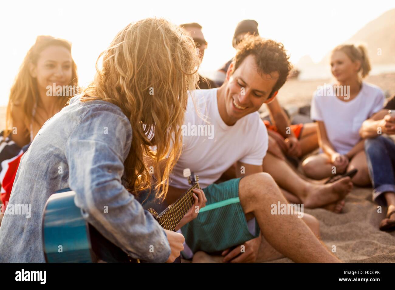 Group of friends camping on beach Stock Photo