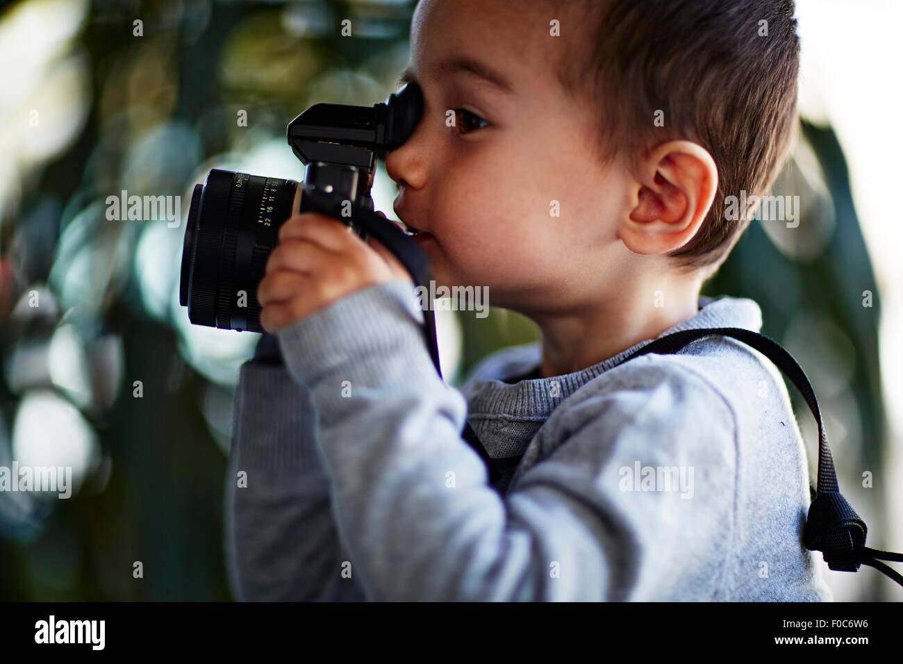 Boy taking photograph with camera Stock Photo - Alamy
