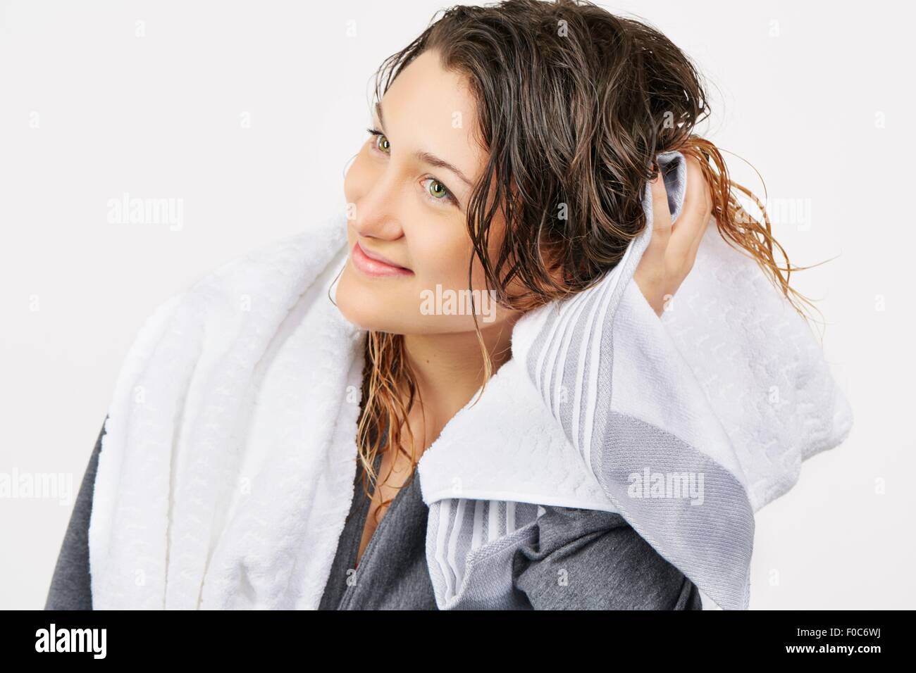 Young woman towel drying hair Stock Photo