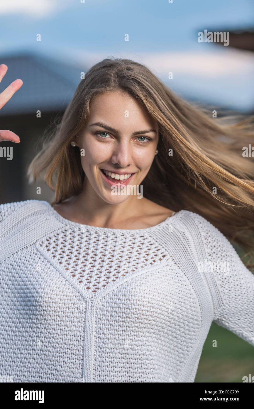 Portrait of beautiful young woman smiling outdoors Stock Photo - Alamy