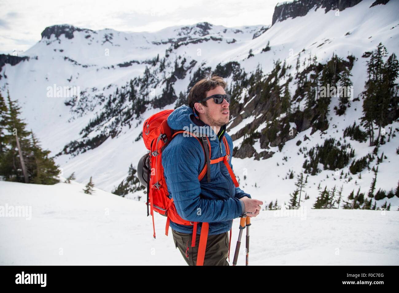 Young male skier looking out from mountainside, Mount Baker, Washington, USA Stock Photo