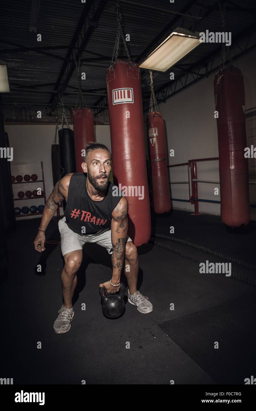 Male boxer preparing to lift kettlebell in gym Stock Photo Alamy