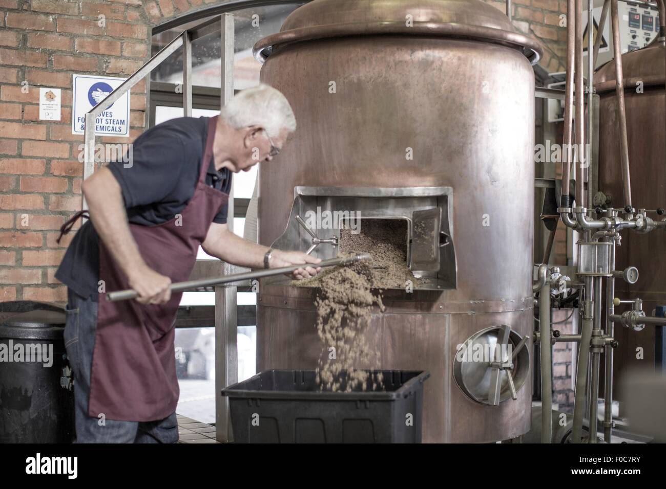 Brewer cleaning a copper kettle in the brewery Stock Photo Alamy