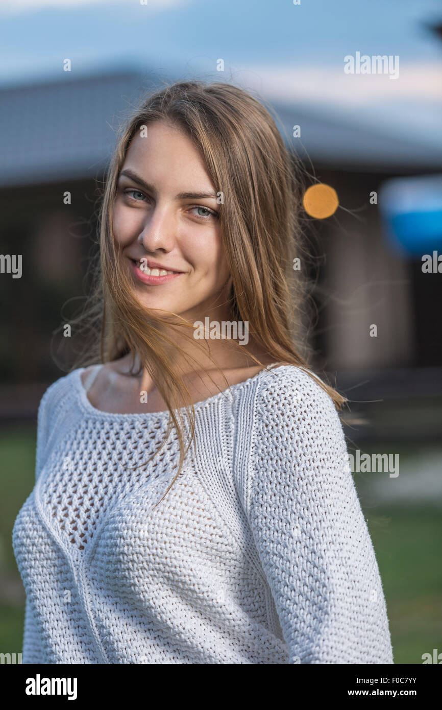 Portrait of beautiful young woman smiling outdoors Stock Photo - Alamy
