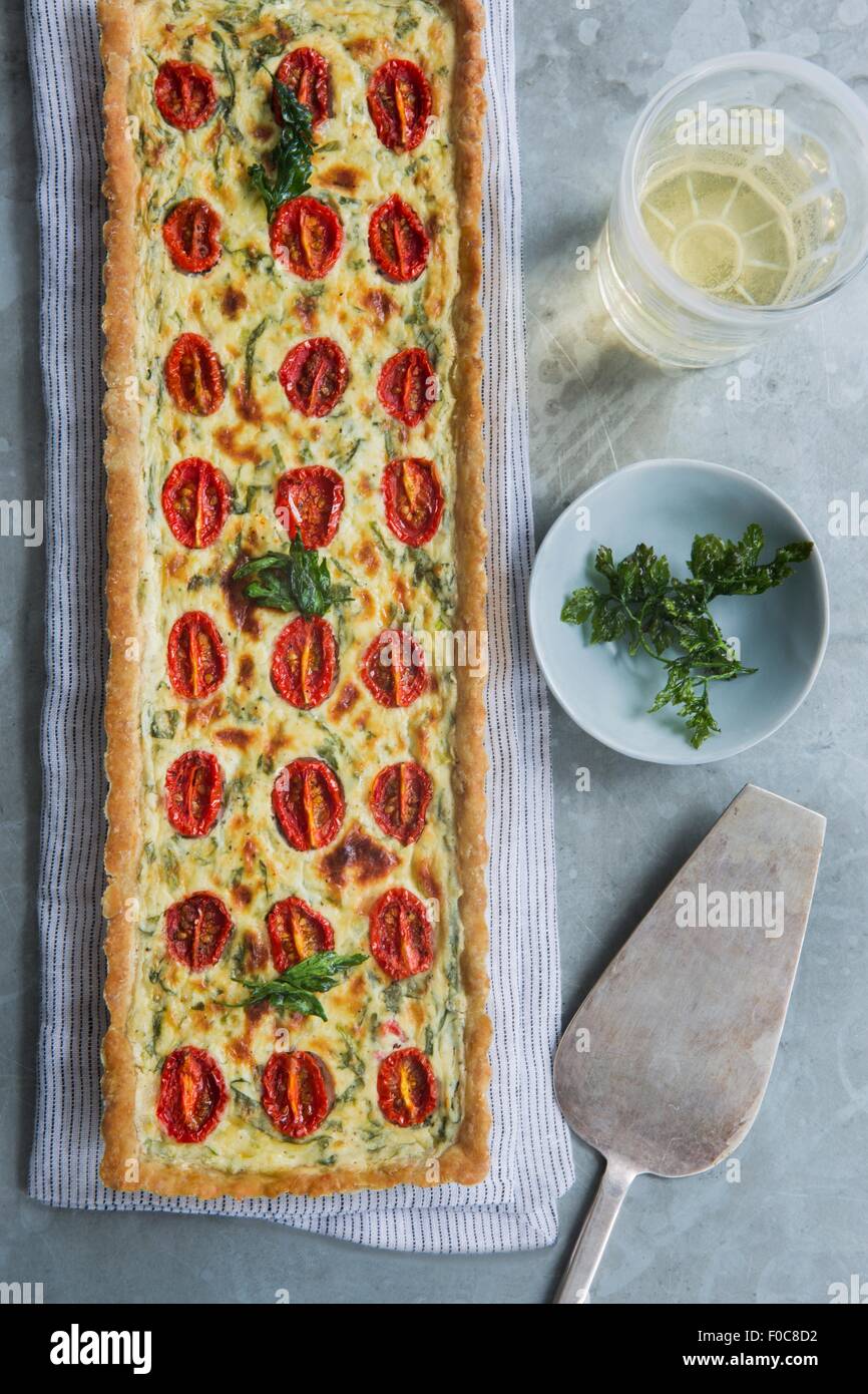 Overhead view of quiche with tomato and herb garnish Stock Photo Alamy