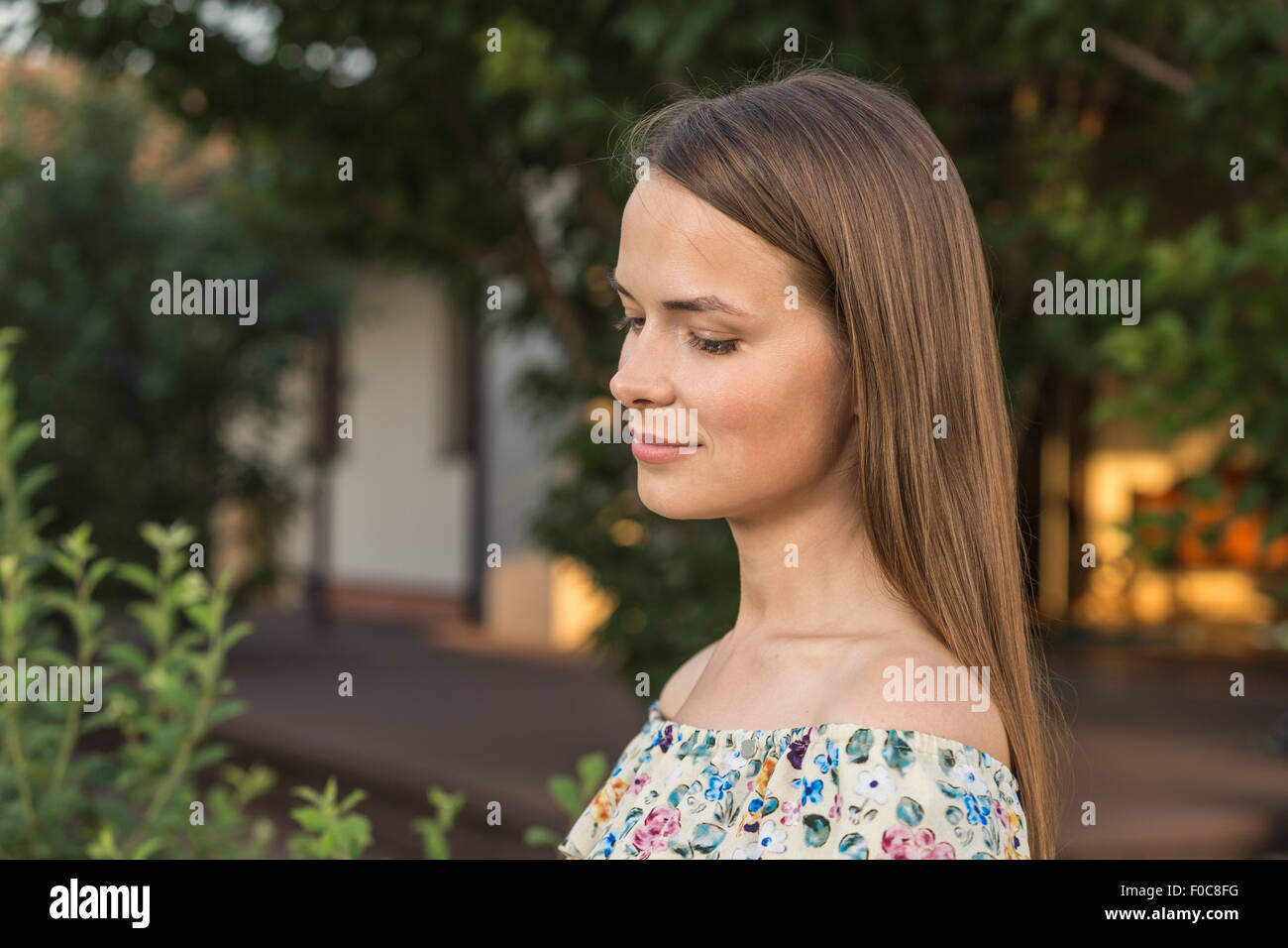 Side view of beautiful young woman outdoors Stock Photo