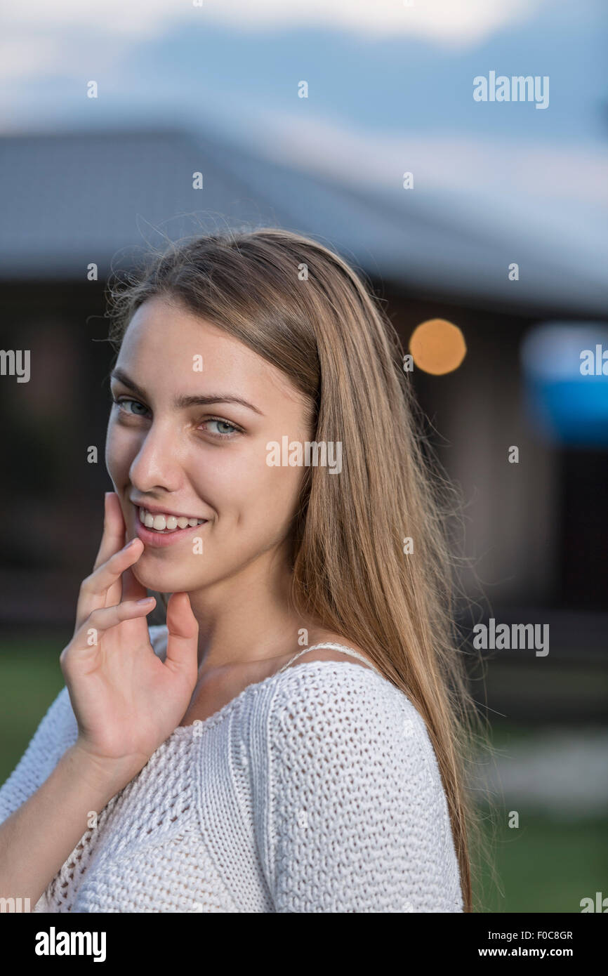 Portrait of beautiful young woman smiling outdoors Stock Photo
