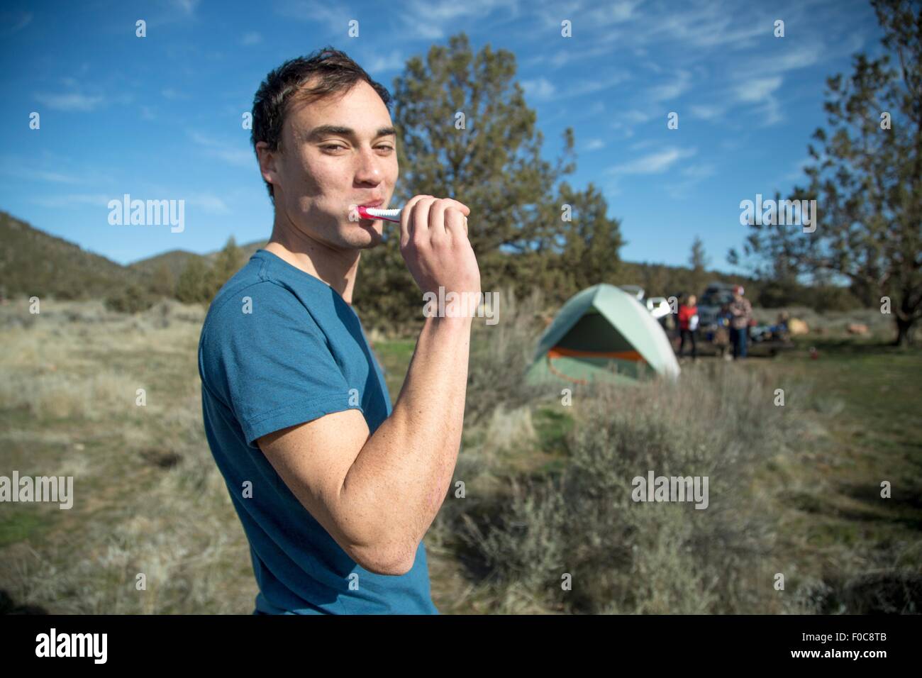 Man brushing teeth at camp, Smith Rock State Park, Oregon Stock Photo