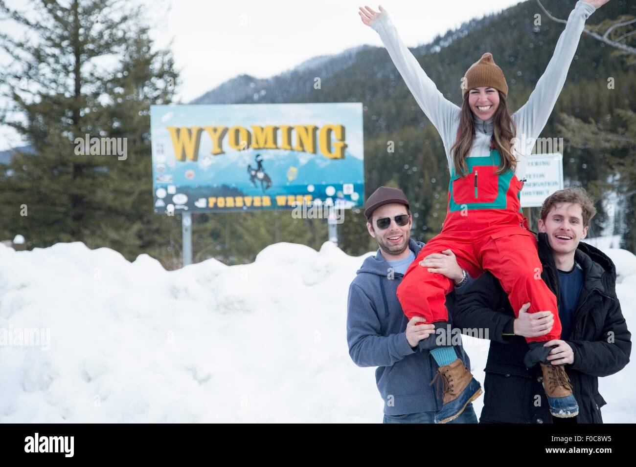 Men carrying woman on shoulder, Jackson Hole, Wyoming Stock Photo