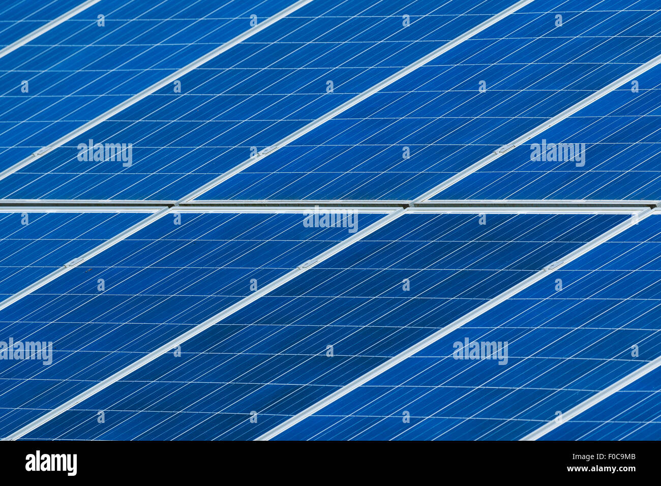 Solar panels grid on roof generating electricity close up. Sustainable green energy. Stock Photo