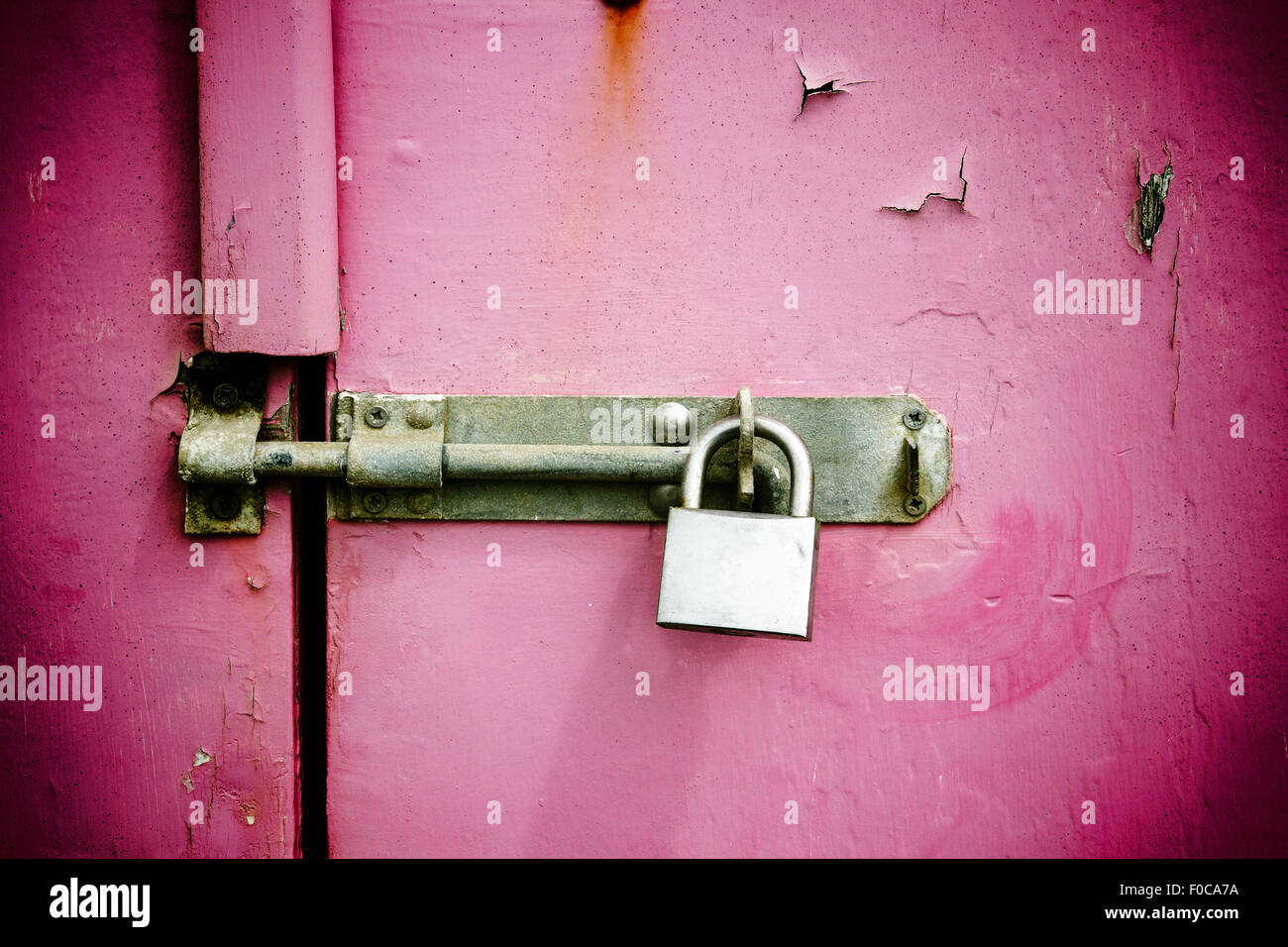 Rusty padlock on old pink painted wooden door Stock Photo - Alamy