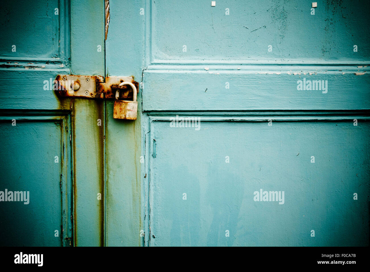 Rusty padlock on old blue painted wooden door Stock Photo - Alamy