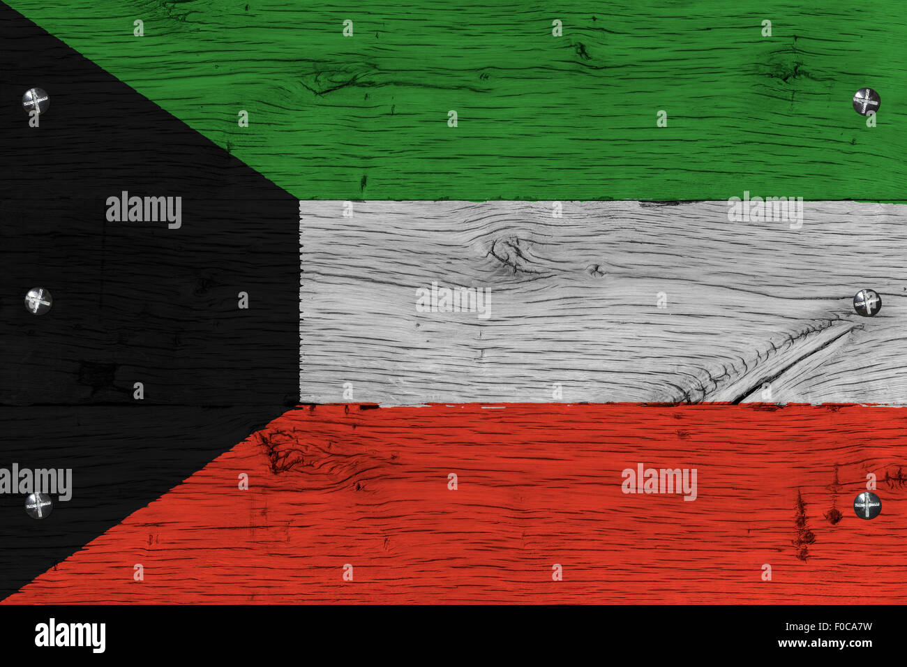 Kuwait national flag. Painting is colorful on wood of old train carriage. Fastened by screws or bolts. Stock Photo