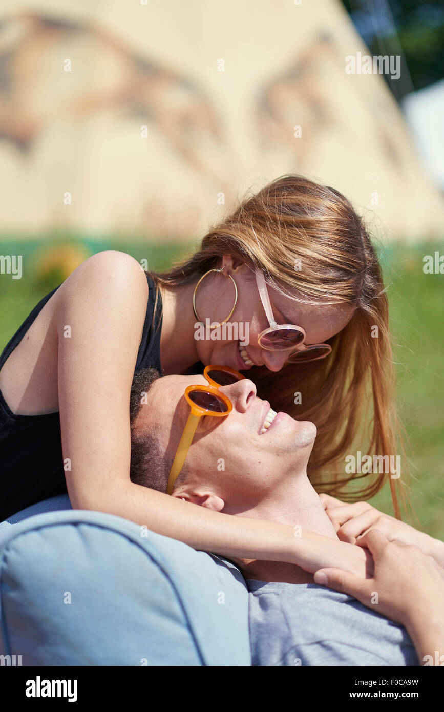 Happy couple looking at each other while glamping Stock Photo