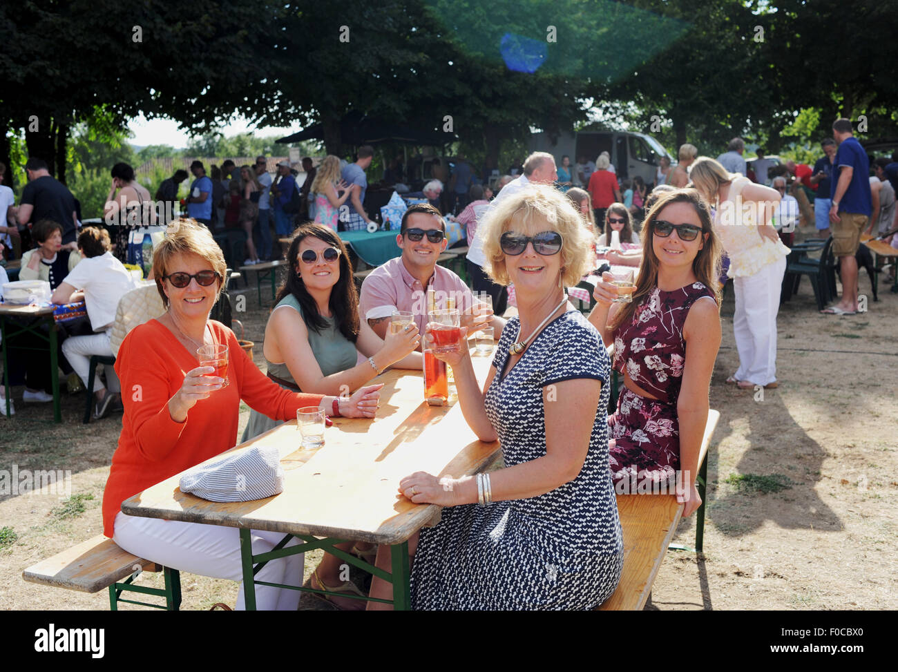 Family and friends on holiday enjoy the Picnic evening at Loubejac which is a small commune or village in the Dordogne region Stock Photo