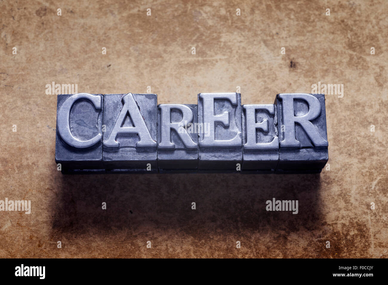 career word made from metallic letterpress type on vintage cardboard Stock Photo