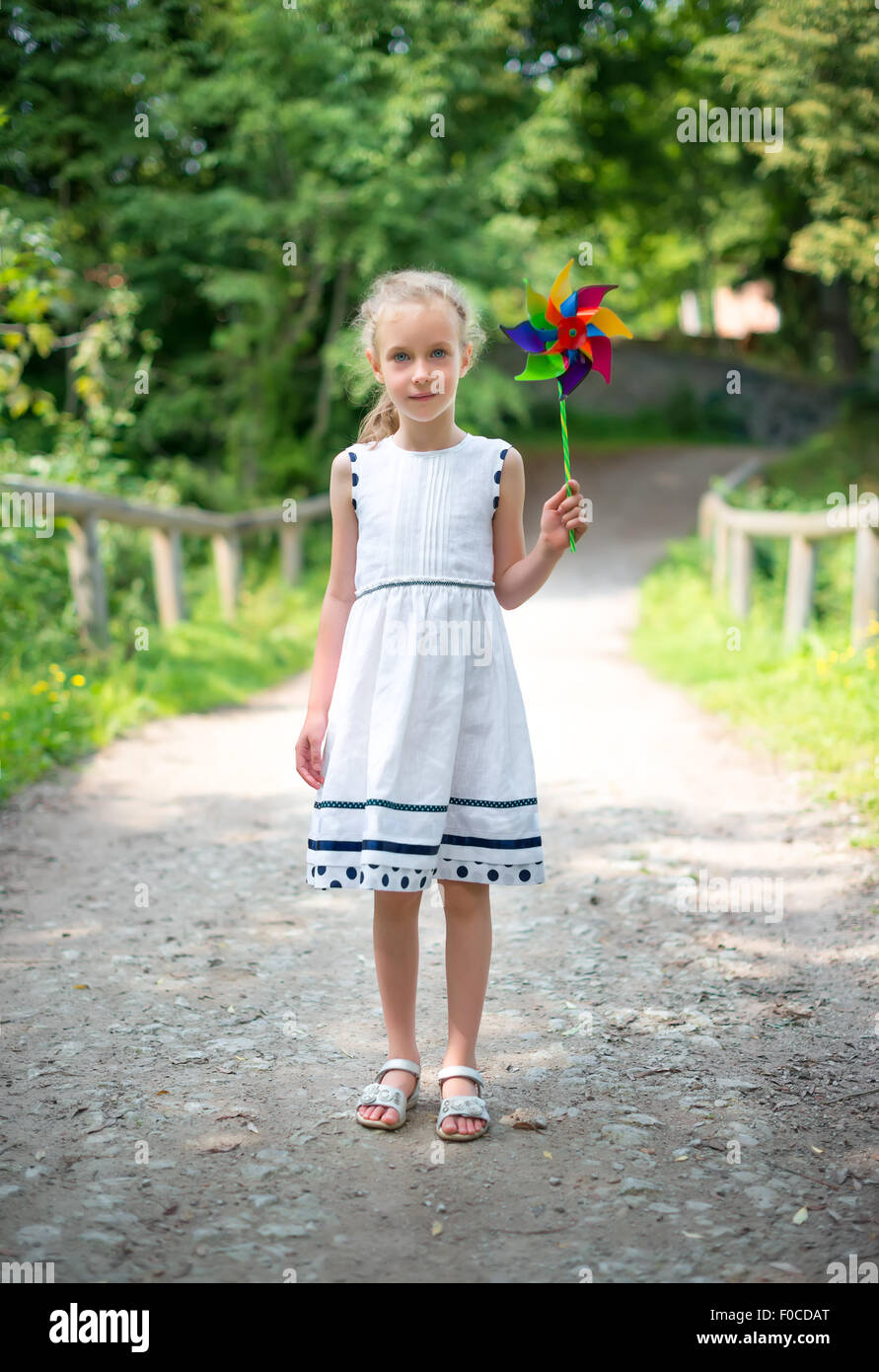 Little girl with colorful pinwheel in the park Stock Photo - Alamy