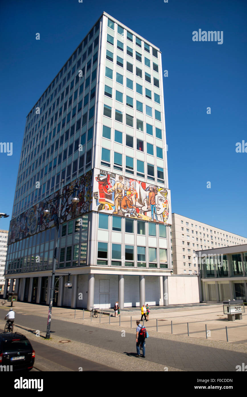 Building along Karl Marx alley with mosaic showing workers, Berlin Stock Photo