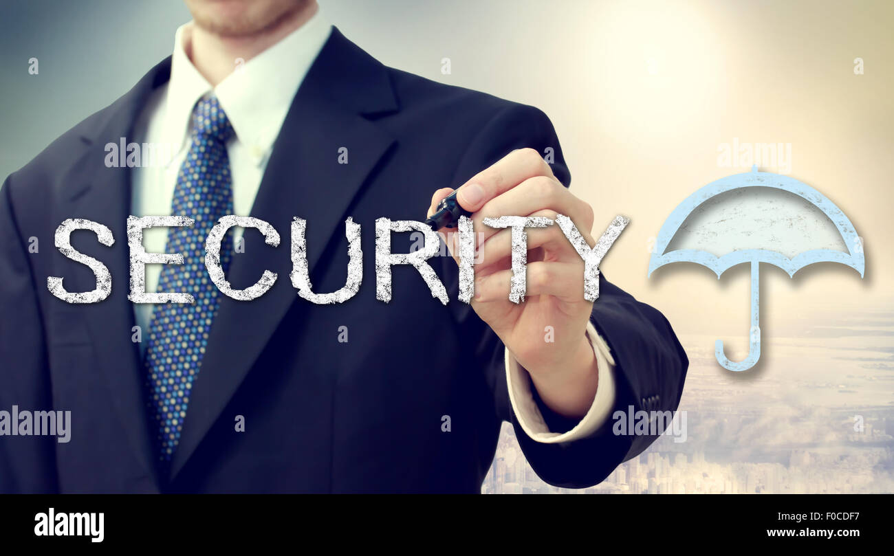 Businessman drawing security text and umbrella picture Stock Photo