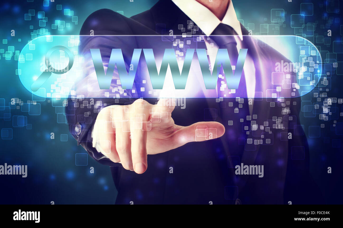 Businessman pressing WWW search button on blue background Stock Photo