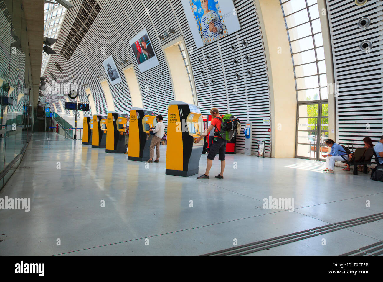 Customers using automatic ticket machines at Avignon TGV railway station Stock Photo