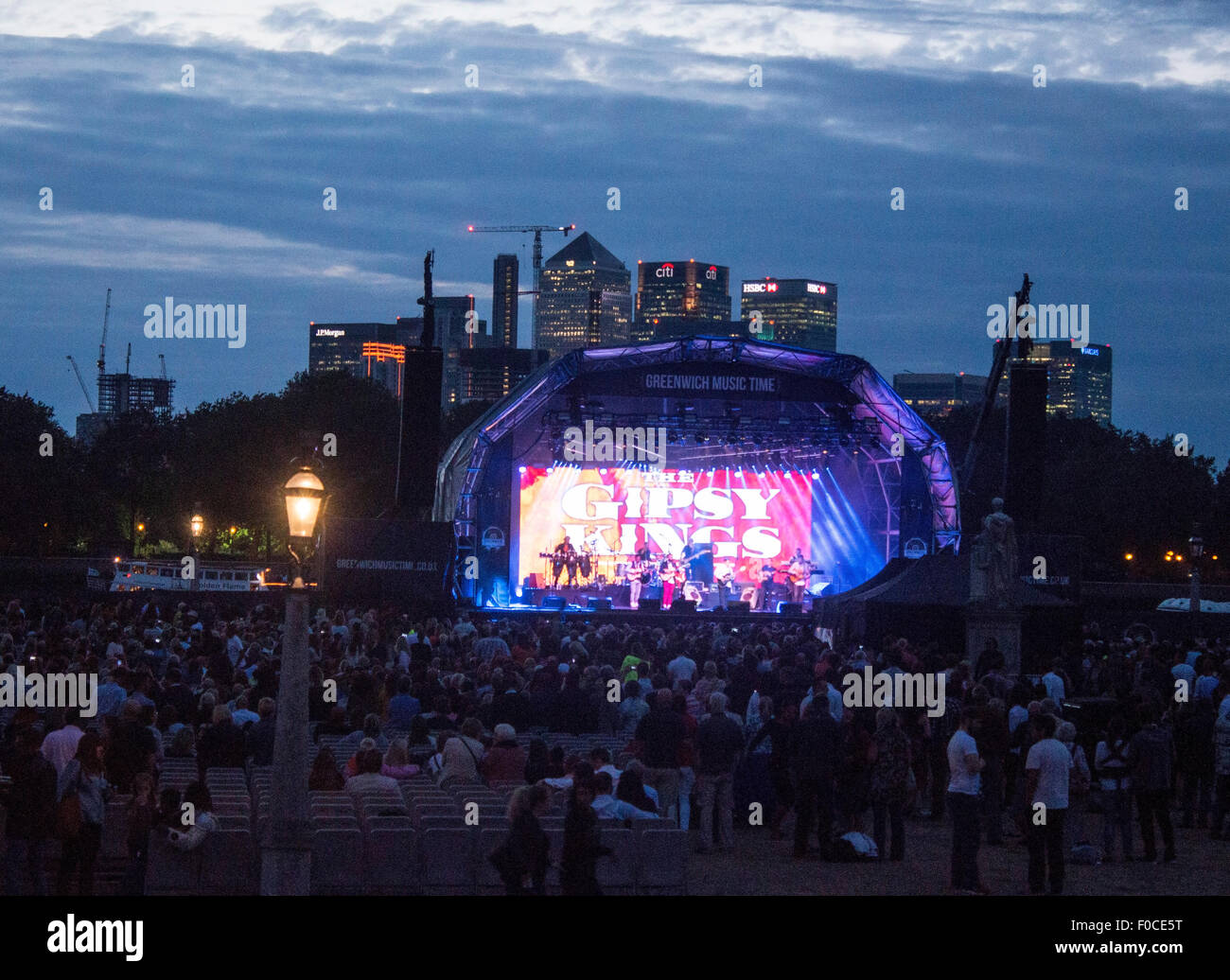 Greenwich Music Time Gipsy Kings performance at Old Royal NAval College  Greenwich with Canary Wharf skyline at dusk in backgroun Stock Photo - Alamy