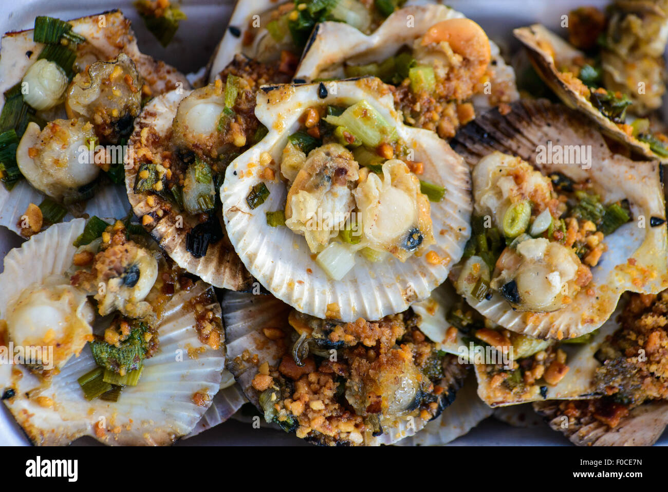 Grilled scallops with green onions and ground peanuts Stock Photo