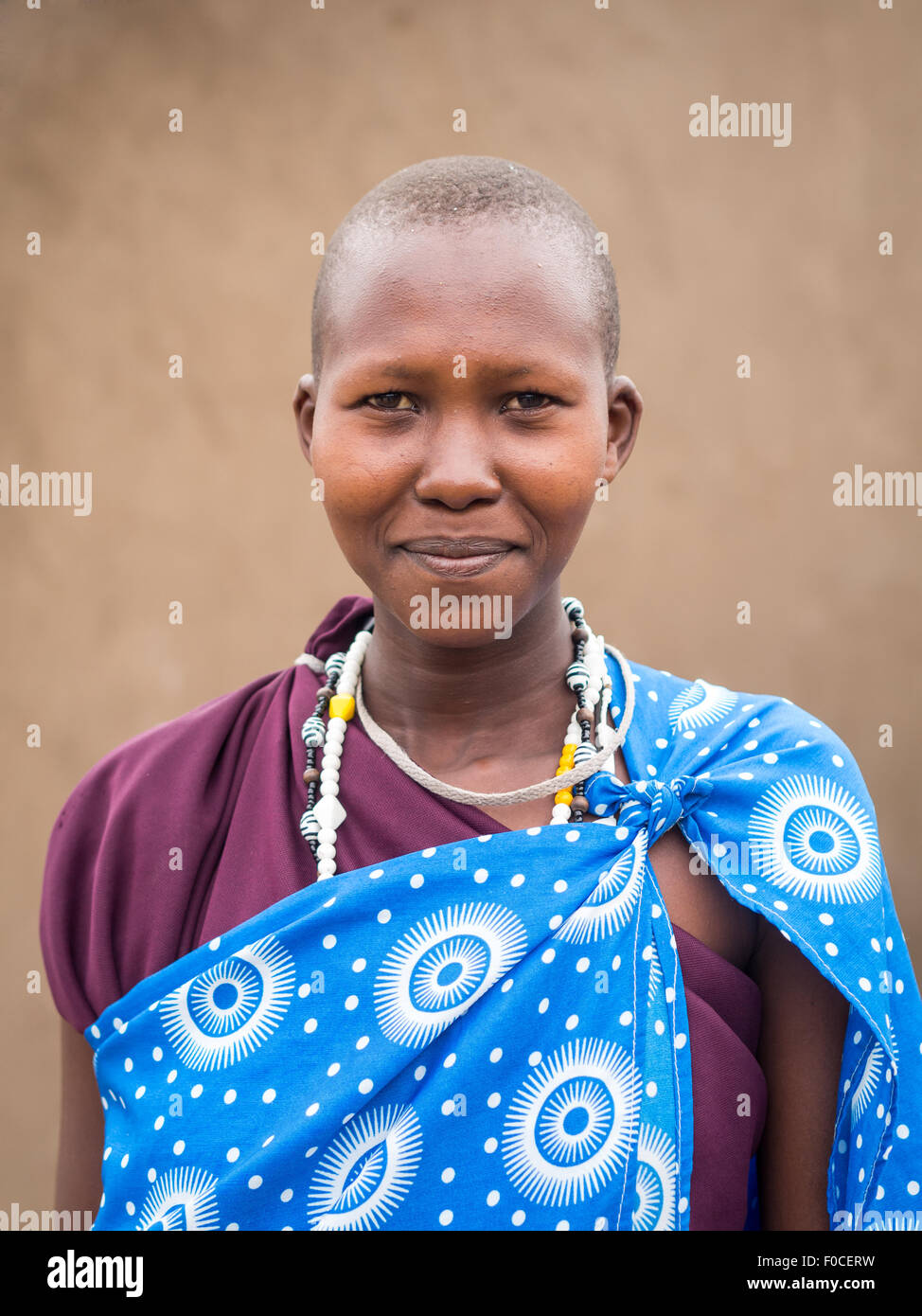 Young Maasai woman in traditional everyday clothes in her boma (village) in Tanzania, Afric Stock Photo