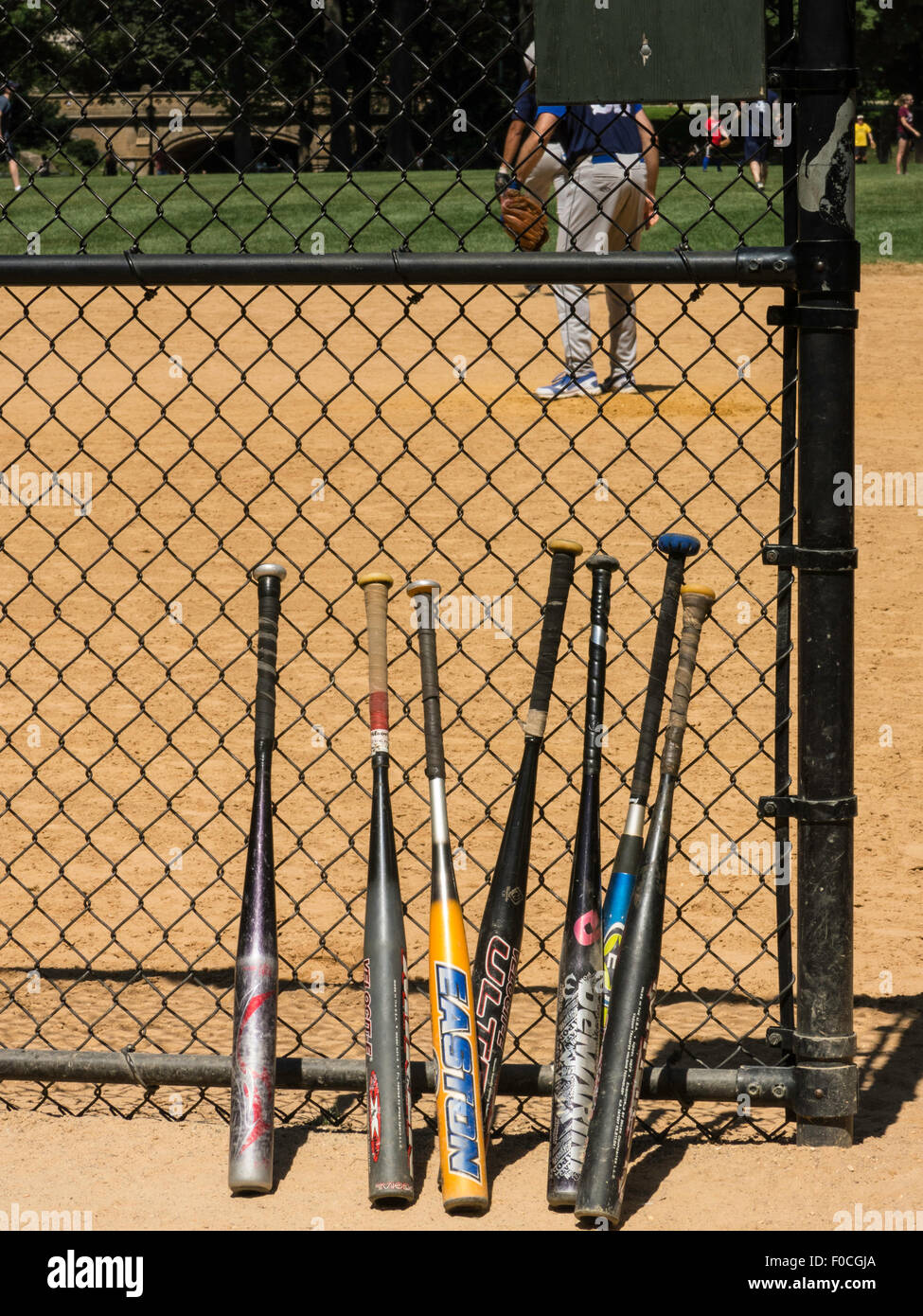 Softball Bats Against the Backstop Fence, Heckscher Ballfields, Central Park, NYC Stock Photo
