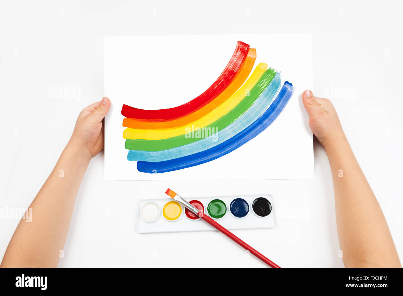 Child draws the rainbow watercolors Stock Photo