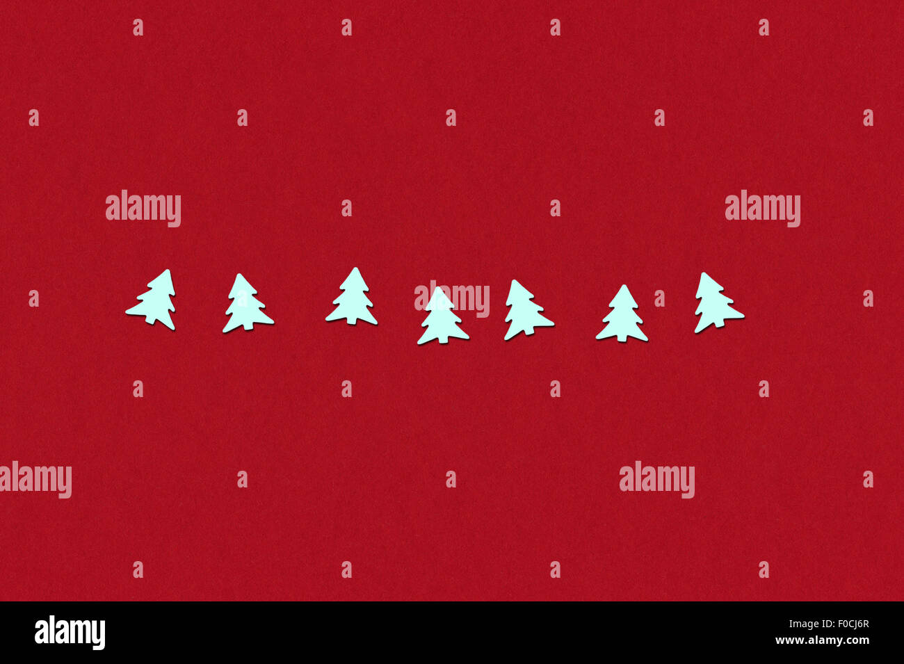 holiday background. confetti in christmas tree form on a red rough