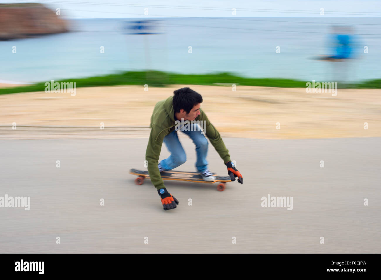 Blured motion of teenagers on a longboard going down the hill. Longboard is a type of sports eq Stock Photo