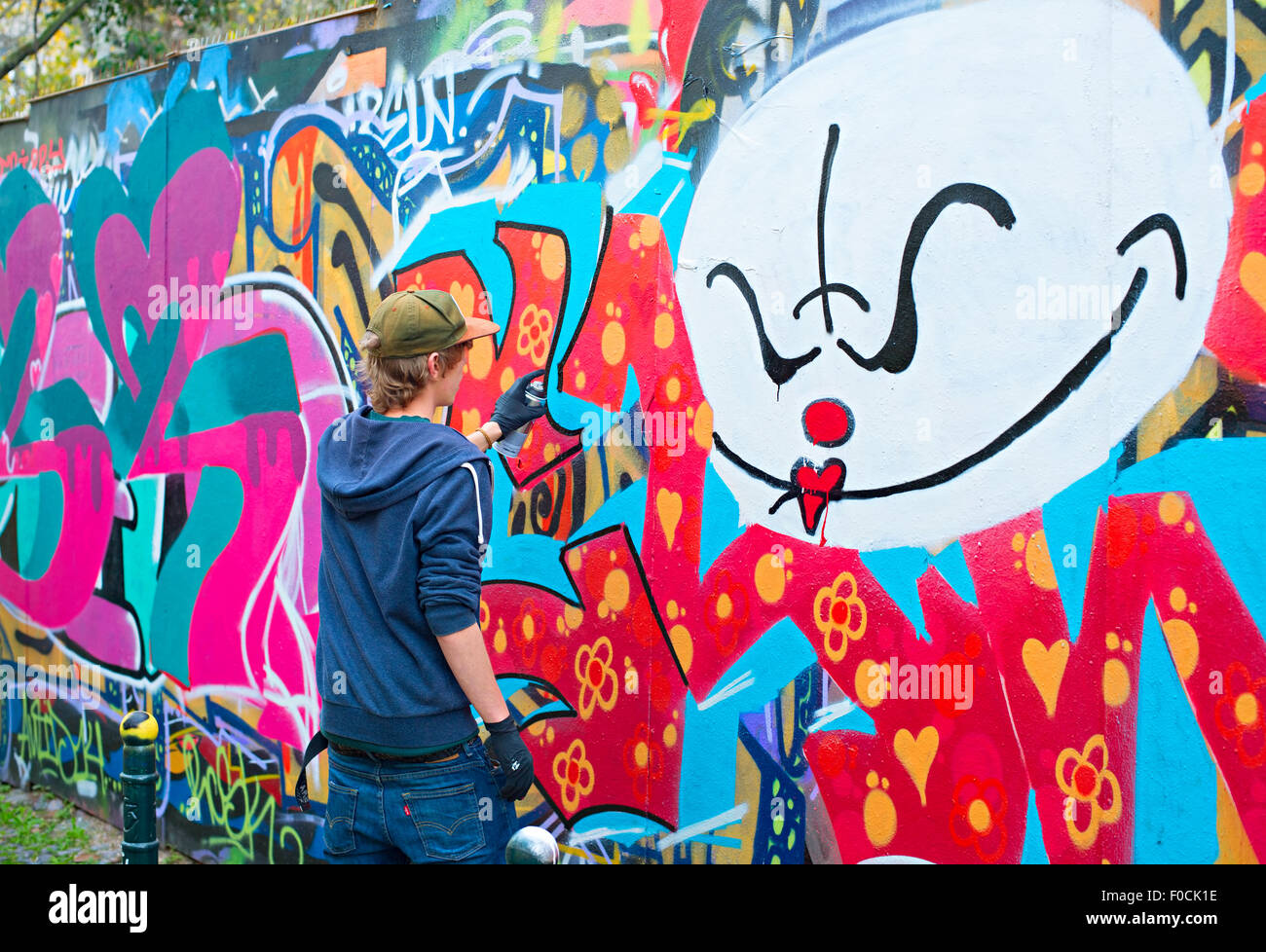 Male Teen Painting Wall Spray Paint High Resolution Stock Photography