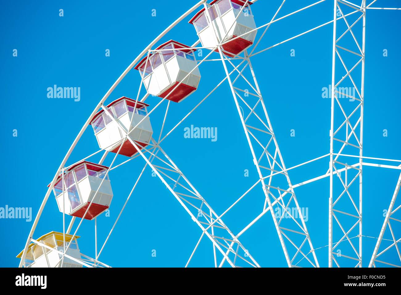 Ferris Wheel Closeup Over Clear Blue Sky. Ferris Wheel Fun. Stock Photo