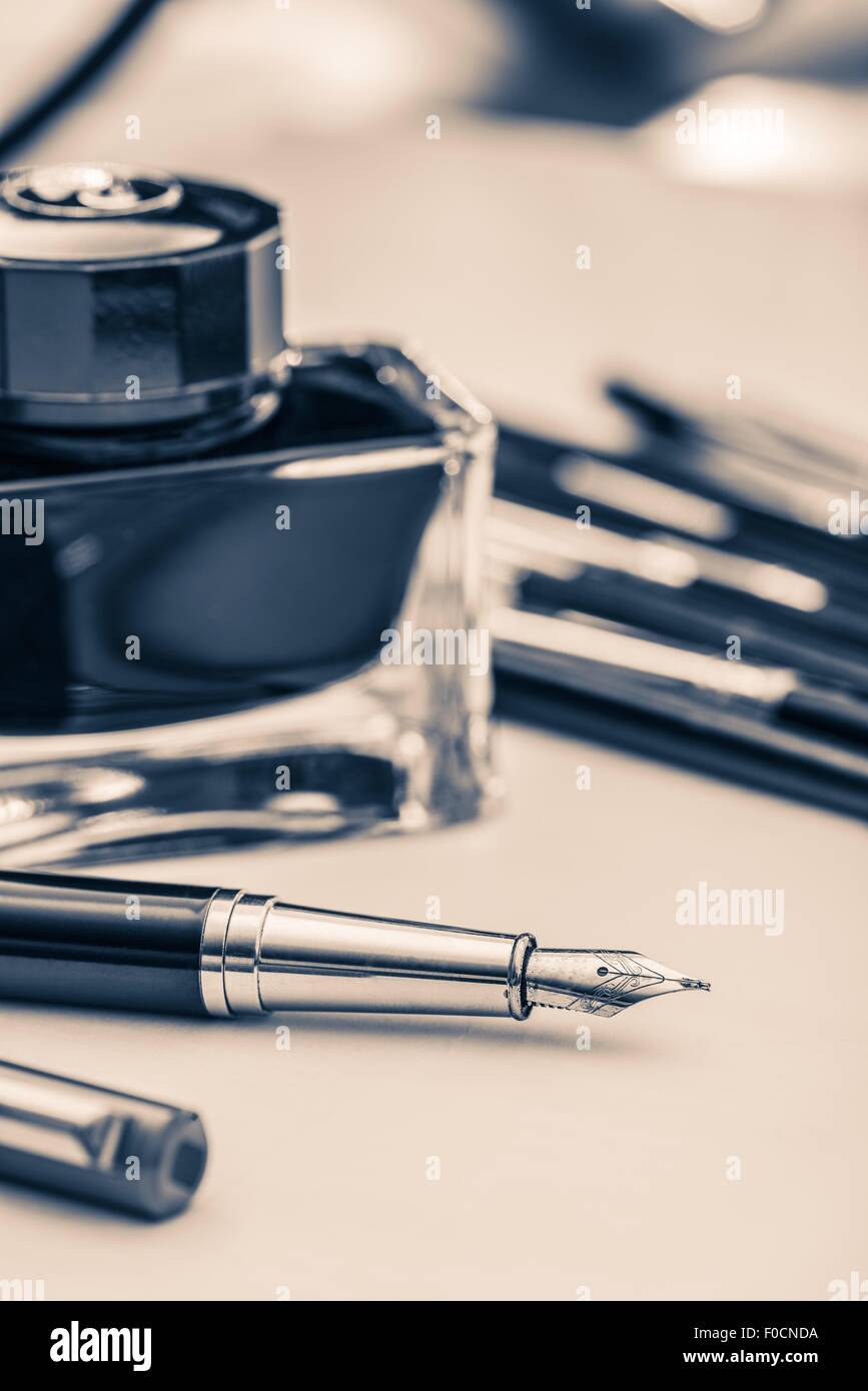 Fountain Pen Handwriting Concept Photo. Fountain Pens and Ink Bottle