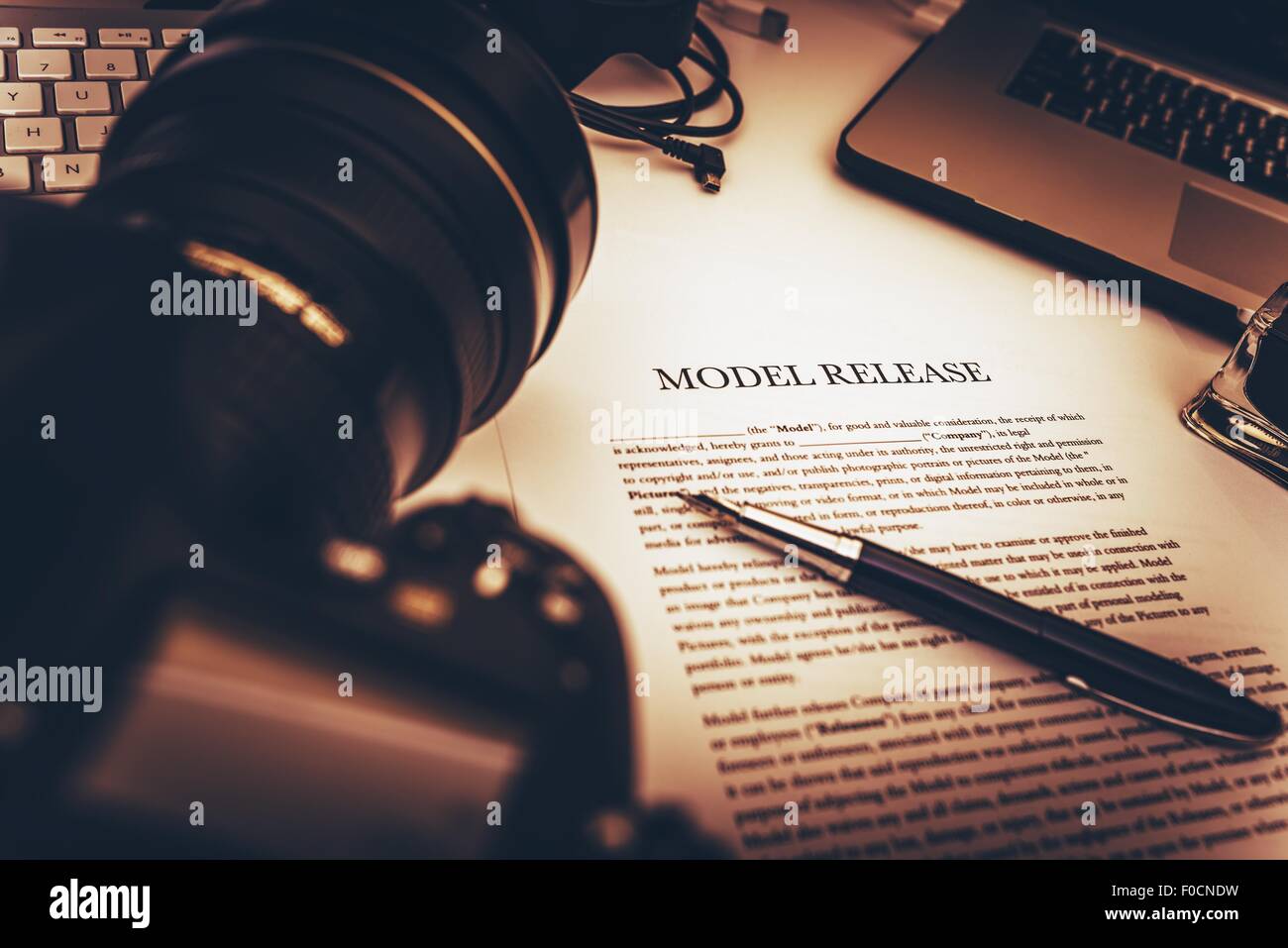 Model Release Signing Photo Concept. Model Release Document and Photo Equipment on a Desk. Stock Photo
