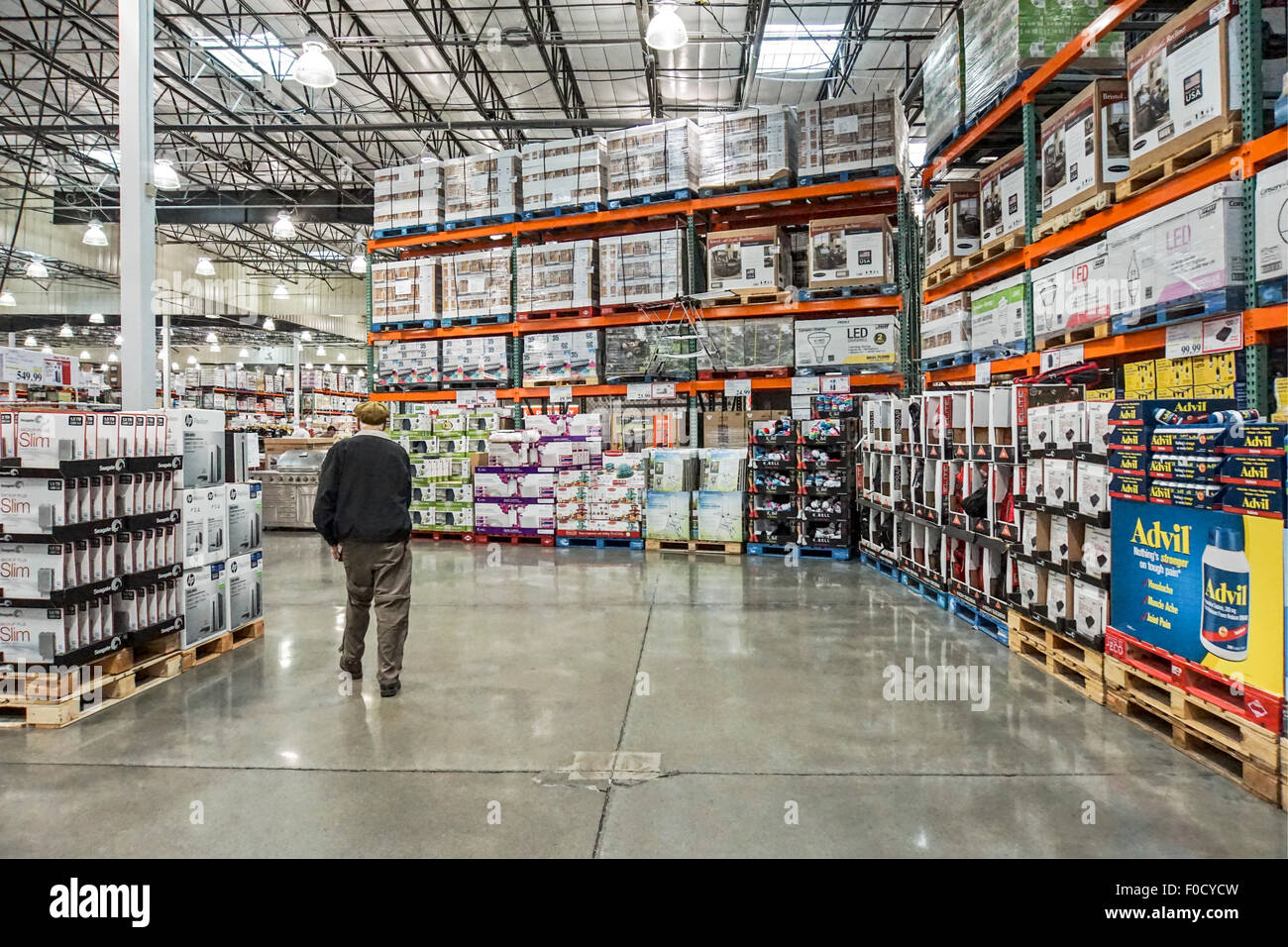 steel shelving stocking large boxed goods stacked on pallets rise to