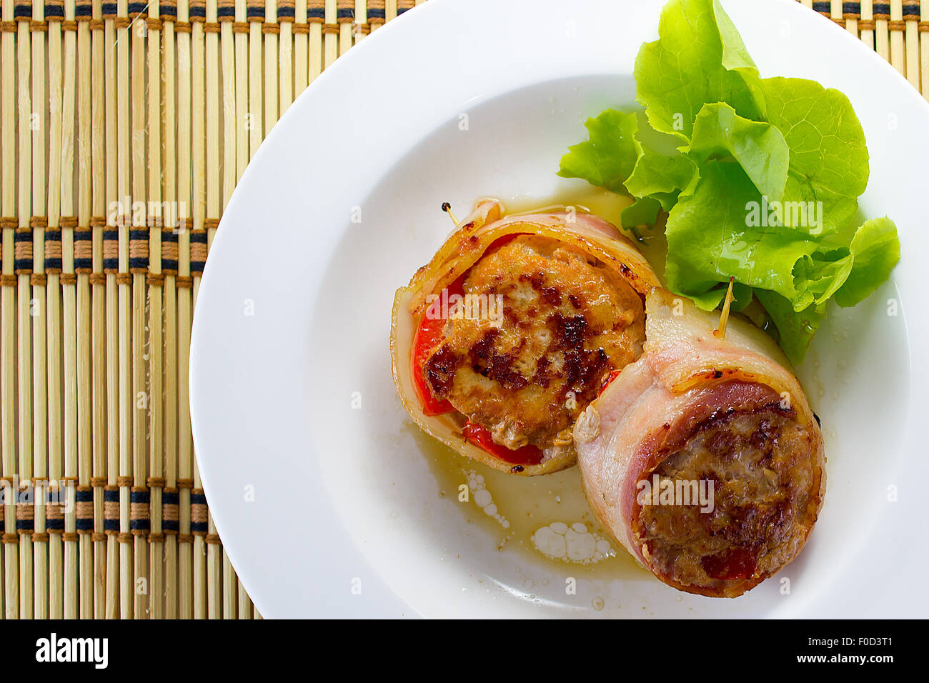 Meat medallions wrapped bacon with vegetable garnish Stock Photo