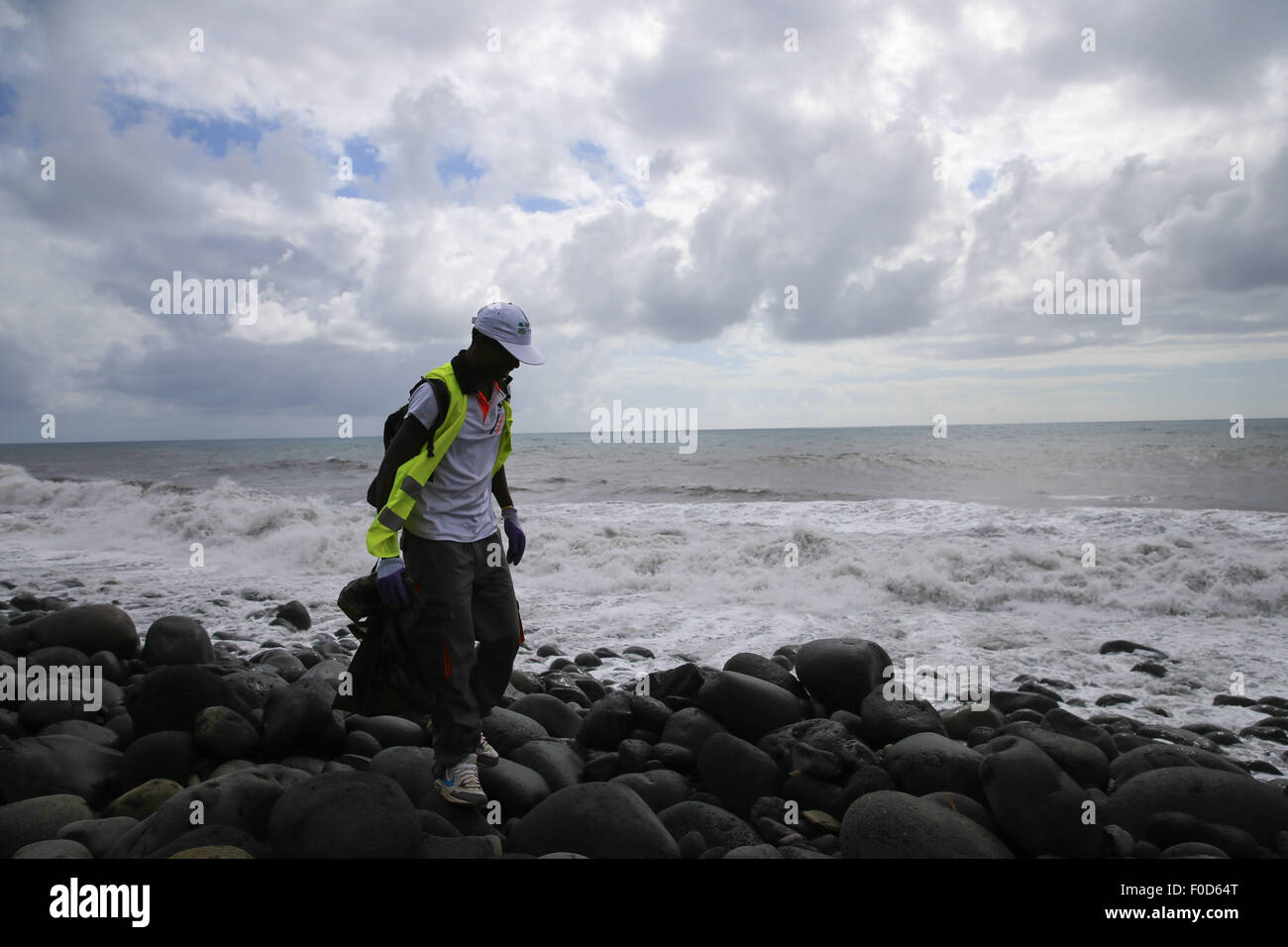 La Reunion, France's oversea island La Reunion. 12th Aug, 2015. A searcher searches the Saint Andre beach, France's oversea island La Reunion, on Aug. 12, 2015. La Reunion authority Monday said that no clues related to the missing flight MH370 has been found here since the launch of a tridimensional search last Friday. Credit:  Pan Siwei/Xinhua/Alamy Live News Stock Photo