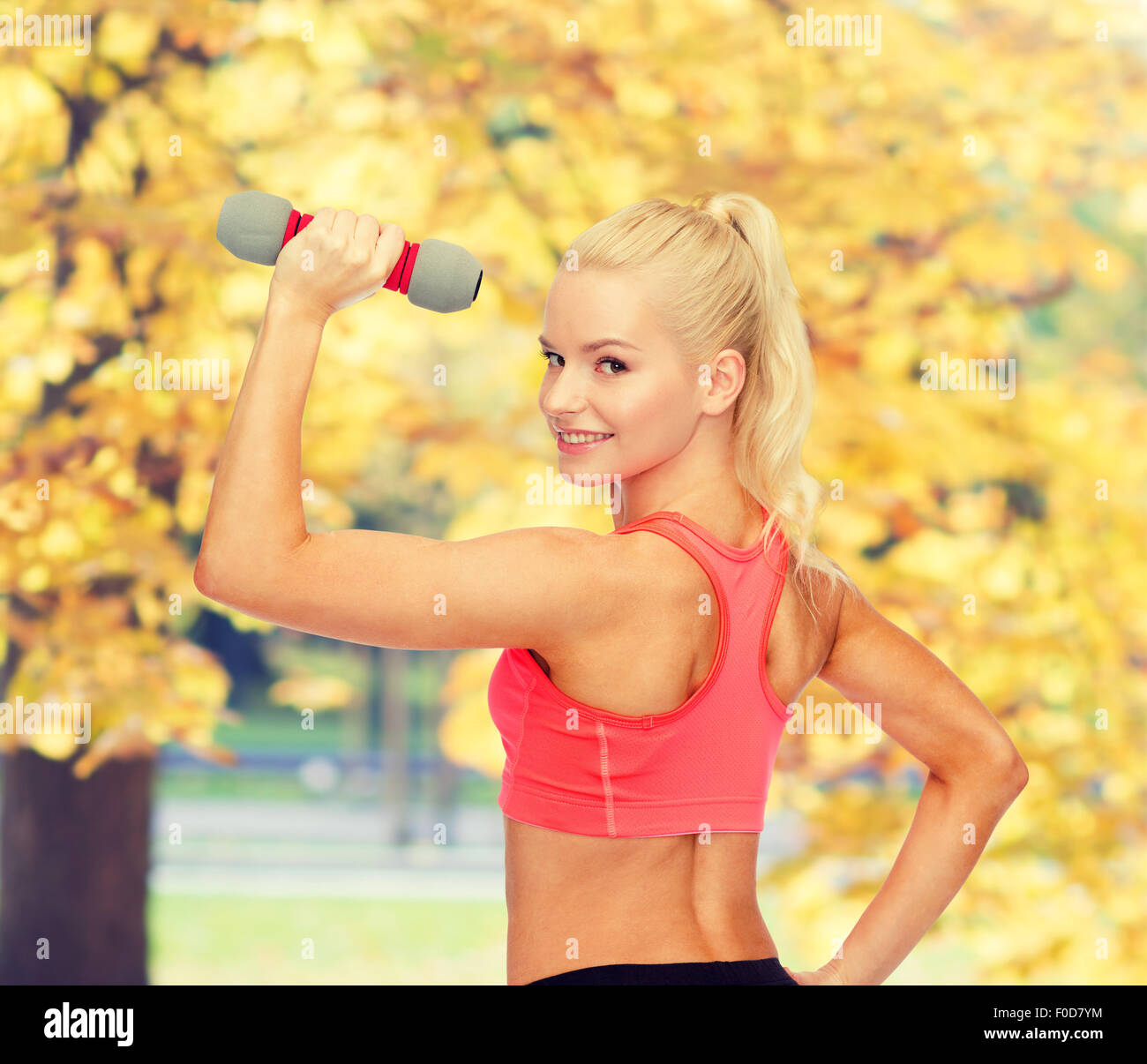 young sporty woman with light dumbbell Stock Photo