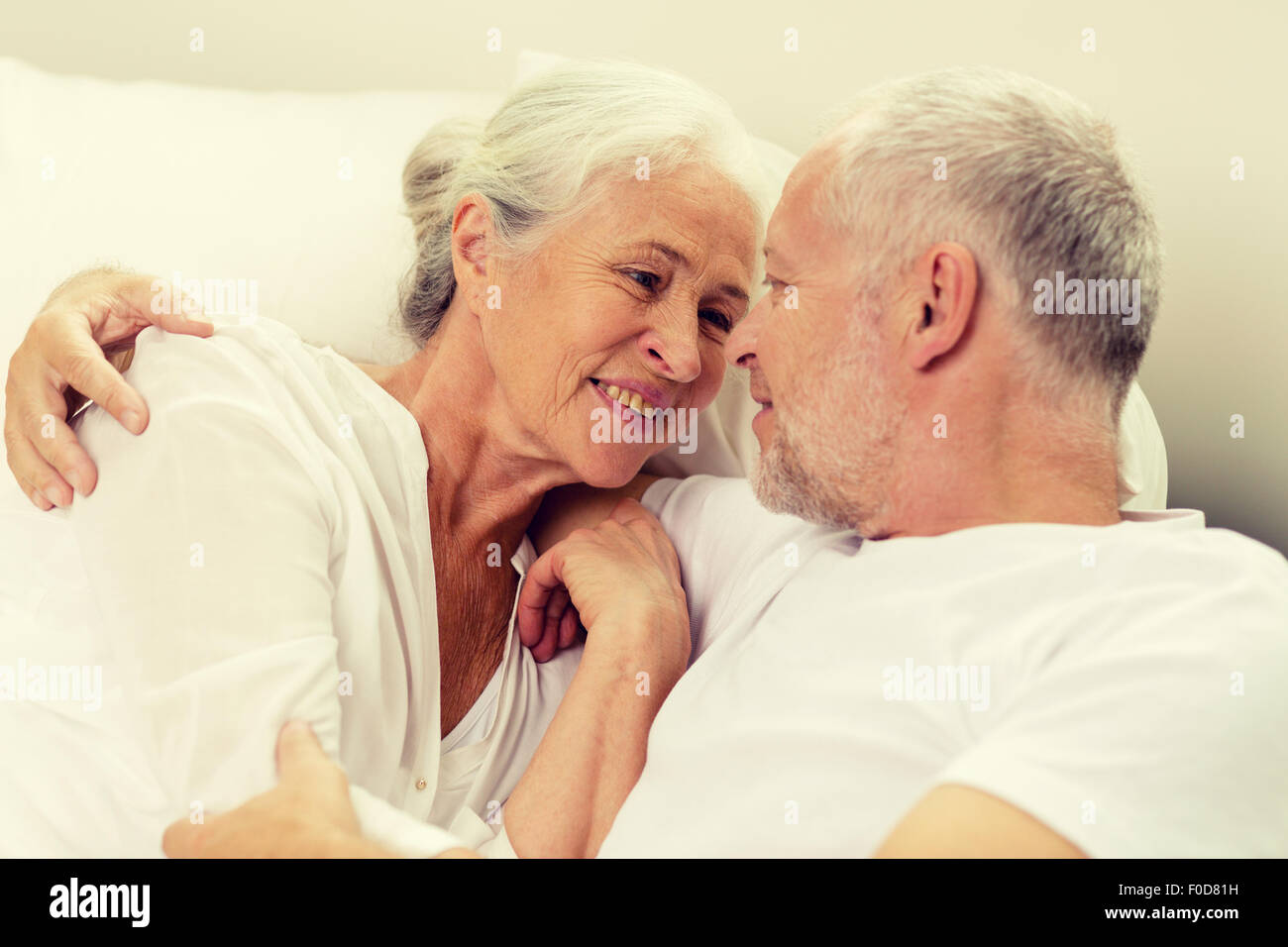 Old couple embracing in bed hi-res stock photography and images - Alamy