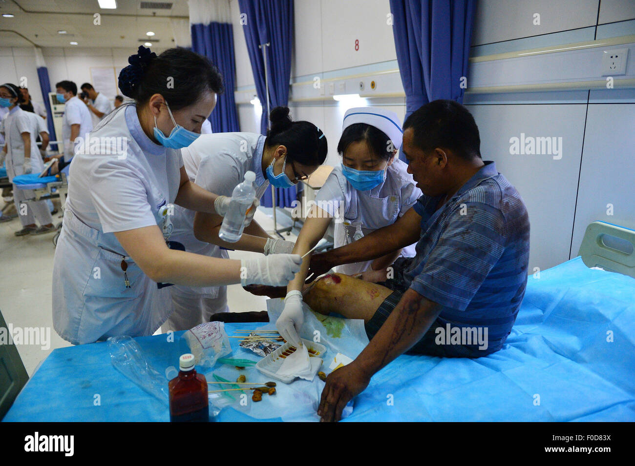 Tianjin. 13th Aug, 2015. A man injured in the explosion of the Binhai new district receives treatment in Tianjin Taida Hospital in north China's Tianjin Municipality, Aug. 13, 2015. The death toll has climbed to 44 from two massive blasts that ripped through a warehouse in north China's port city of Tianjin as of Thursday noon, according to rescue headquarters. Twelve firefighters were among the dead. Credit:  Xinhua/Alamy Live News Stock Photo